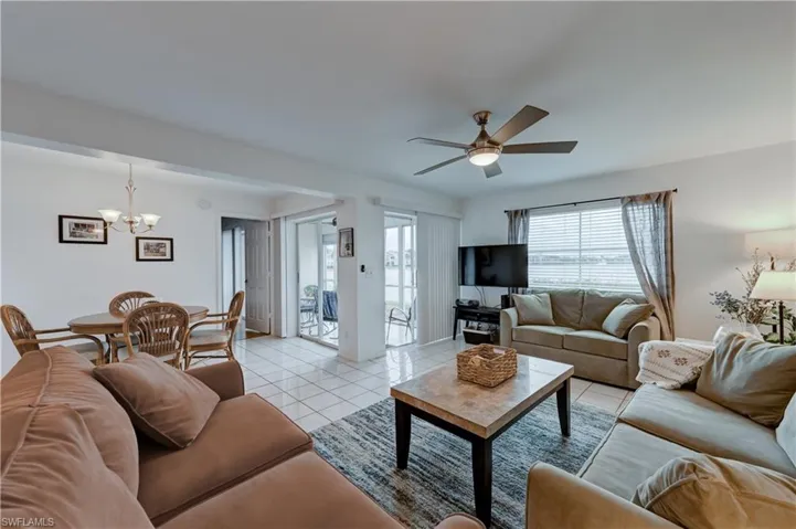 LAKE VIEWS. View of family room, dining area, and screened lanai.