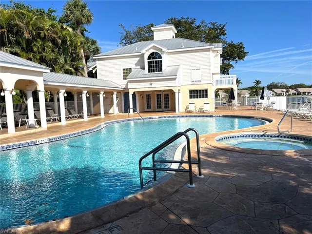 Community pool, hot tub, & clubhouse next to lake, beach, pier and kayak storage area.