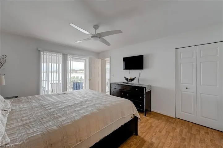 Primary bedroom with walk-in closet and "wake up" view of the lake. King bedroom set.