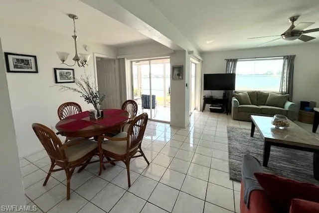 Dining and living areas feature abundant light and lake view.