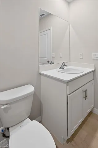 Half bathroom with vanity and toilet