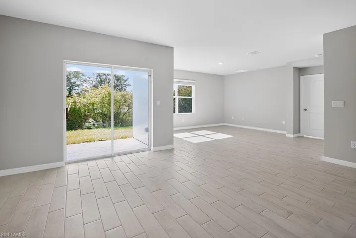 Unfurnished room with baseboards and wood finish floors
