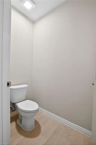 Bathroom featuring baseboards and wood tiled floors
