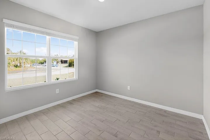 Empty room featuring wood finish floors and baseboards