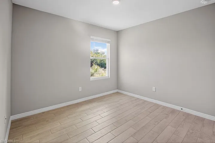 Spare room featuring wood tiled floors