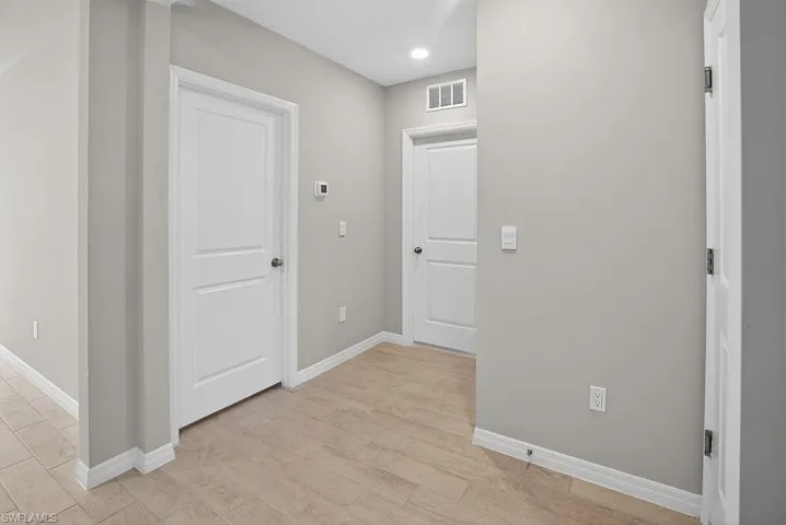 Hallway featuring light wood-style flooring and recessed lighting