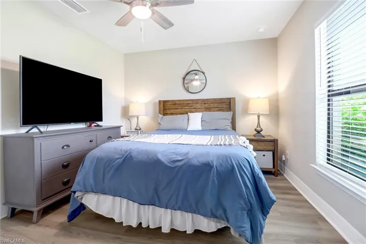 Bedroom with ceiling fan and light wood-type flooring