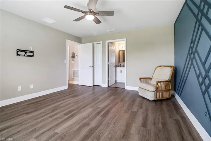 Unfurnished room featuring dark hardwood / wood-style floors and ceiling fan
