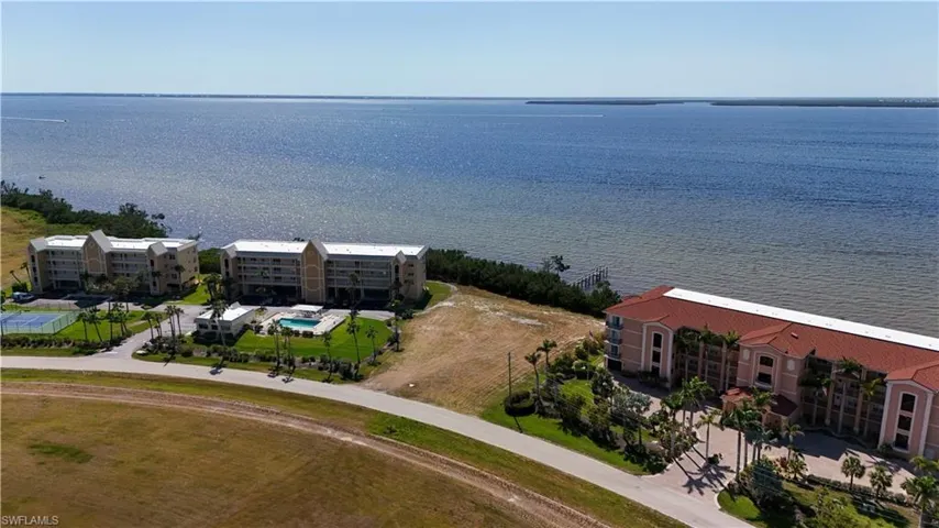 Birds eye view of property with a water view