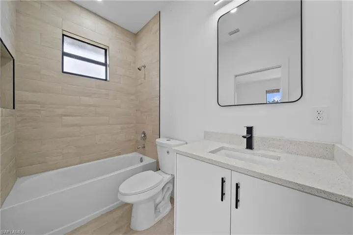 Bathroom featuring vanity and shower / washtub combination