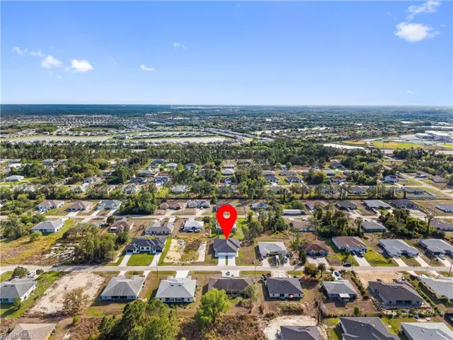 Aerial view of property's location with nearby suburban area