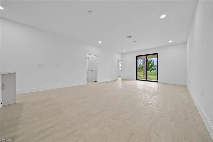 Spare room featuring recessed lighting and wood finish floors