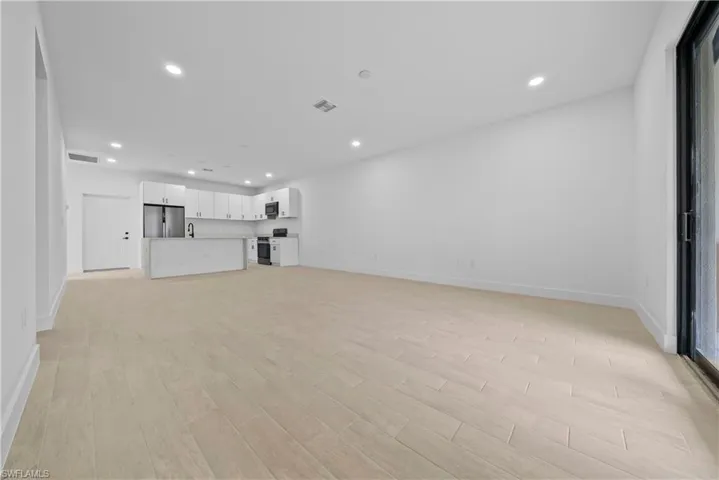 Unfurnished living room with light wood finished floors and recessed lighting