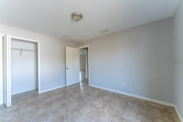 Unfurnished bedroom with baseboards and a closet