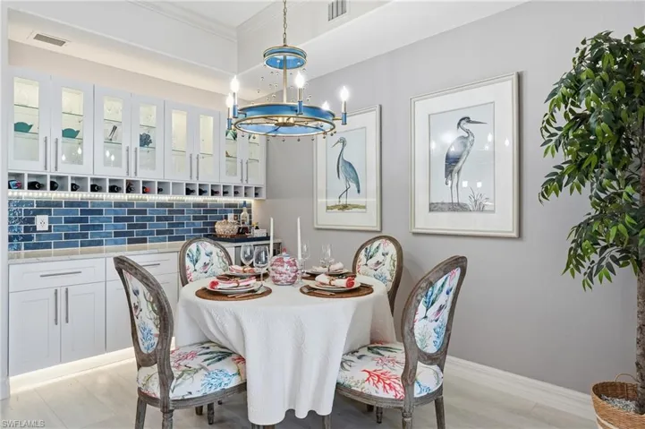Dining area with light wood finished floors and a chandelier