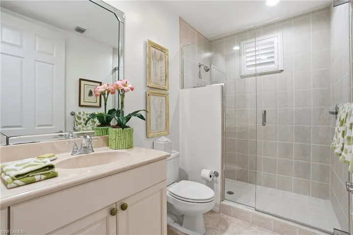 Full bathroom featuring vanity and a shower stall