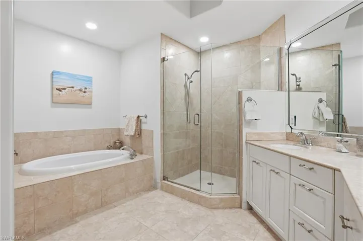 Full bathroom with vanity, a stall shower, a bath, recessed lighting, and light tile patterned flooring