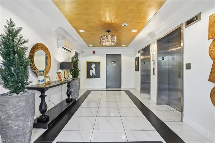 Hall featuring light marble finish flooring, recessed lighting, wood ceiling, inlaid floor details, and ornamental molding