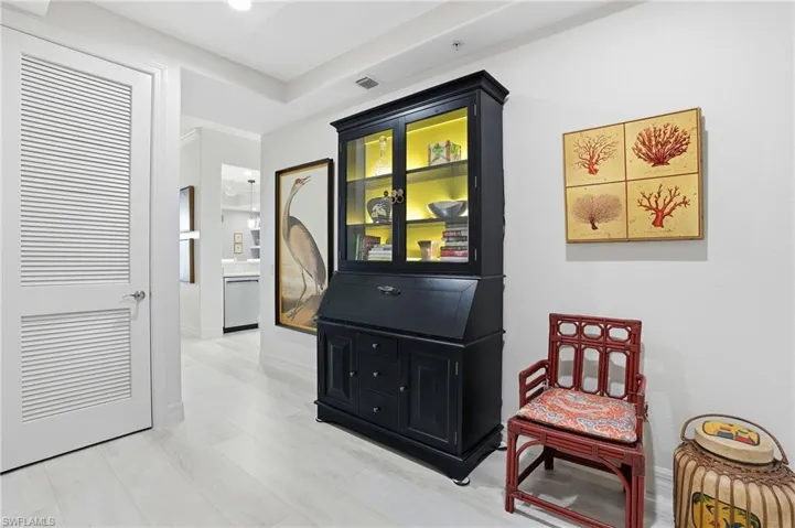 Corridor with baseboards and light wood-style flooring