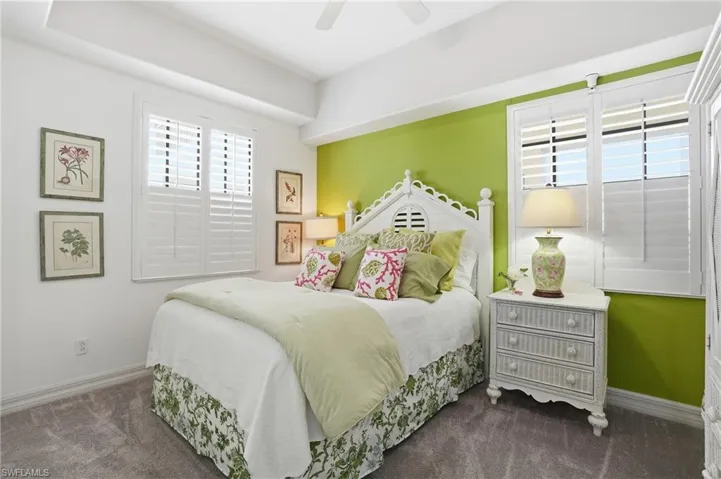 Bedroom featuring dark carpet and a ceiling fan