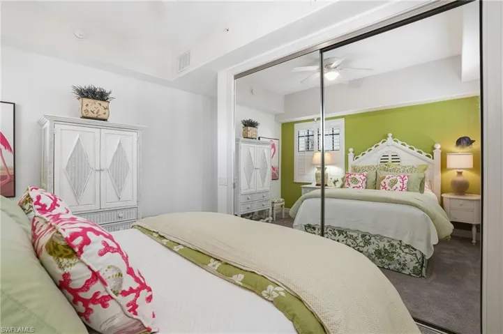 Carpeted bedroom featuring a closet and a ceiling fan