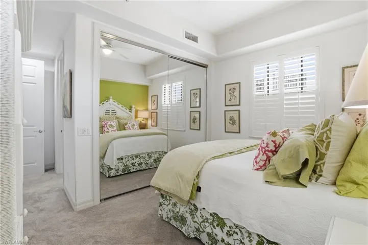 Carpeted bedroom with a closet and baseboards