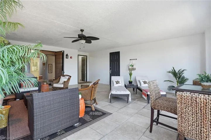 View of patio with an outdoor living space and a ceiling fan