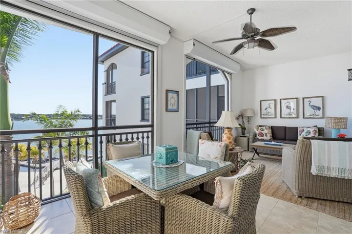 Dining area with a ceiling fan, a water view, and a textured ceiling