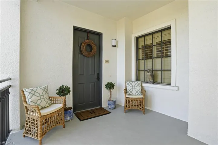 Doorway to property with stucco siding