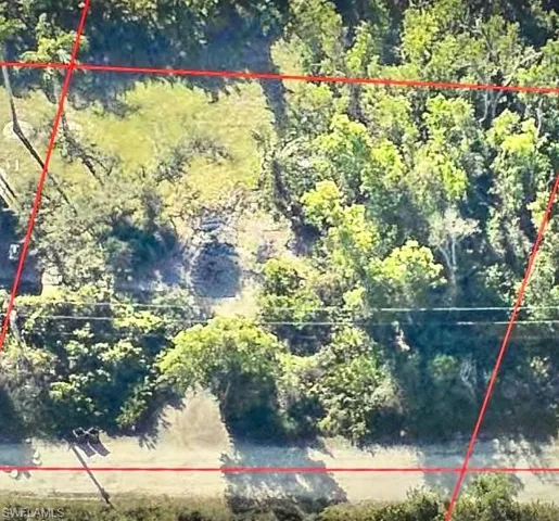 Aerial view of property and surrounding area with property parcel outlined