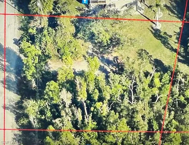 Aerial view of property and surrounding area featuring property boundaries highlighted