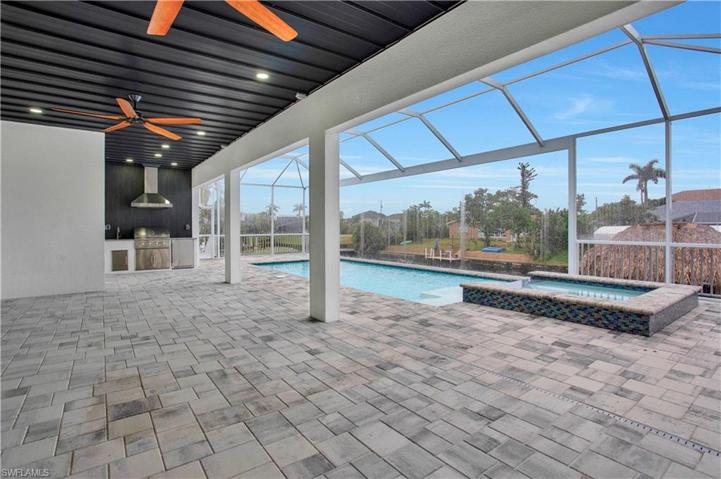 Lanai with outdoor kitchen, pool and spa