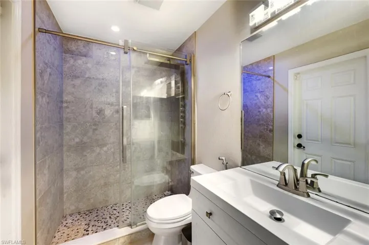 Full bathroom featuring a stall shower and vanity