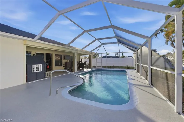 View of swimming pool featuring a sunroom, a lanai, and a patio area