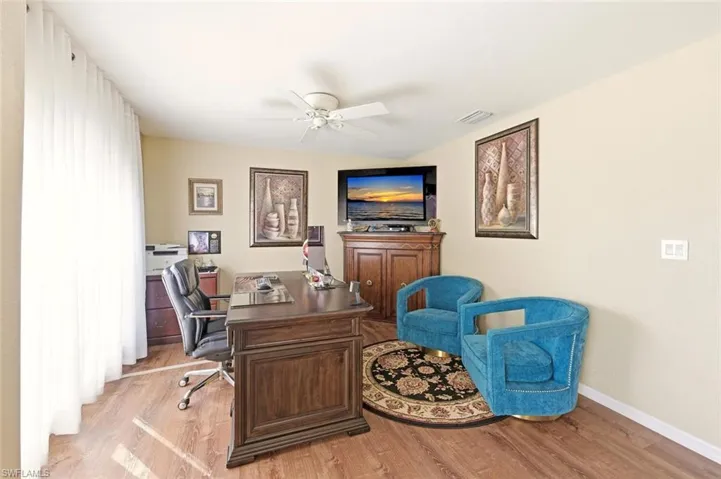 Office area featuring light wood finished floors and ceiling fan