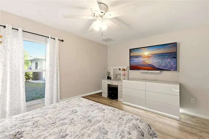 Bedroom with light wood-style floors and ceiling fan