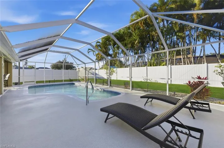 View of swimming pool with a sunroom, a patio area, a lanai, and a fenced backyard