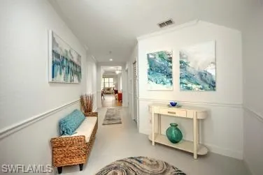 Corridor featuring baseboards and finished concrete floors