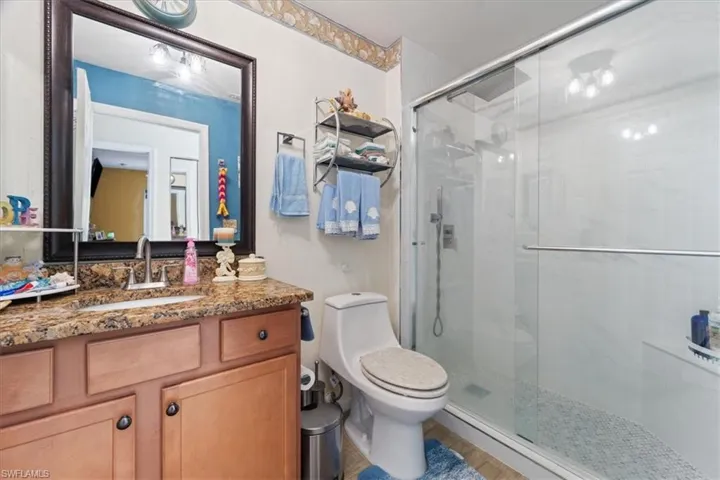 Bathroom with a stall shower and vanity