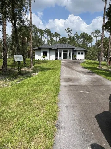 Single story home featuring a front lawn