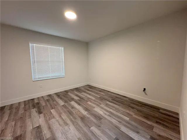 Empty room with wood-type flooring