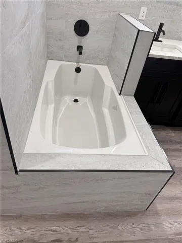 Bathroom featuring vanity and a bathtub