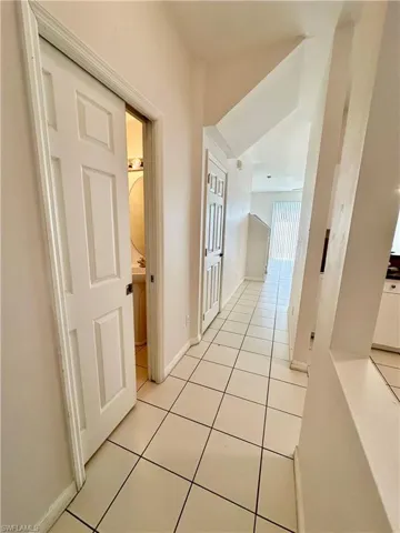 Interior Entryway with half bath left and kitchen right