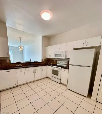 Tiled kitchen with Solid Surface Countering/Backslash