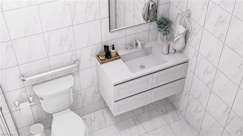 Bathroom with vanity and tile walls