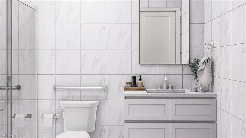 Full bath featuring vanity and tile walls