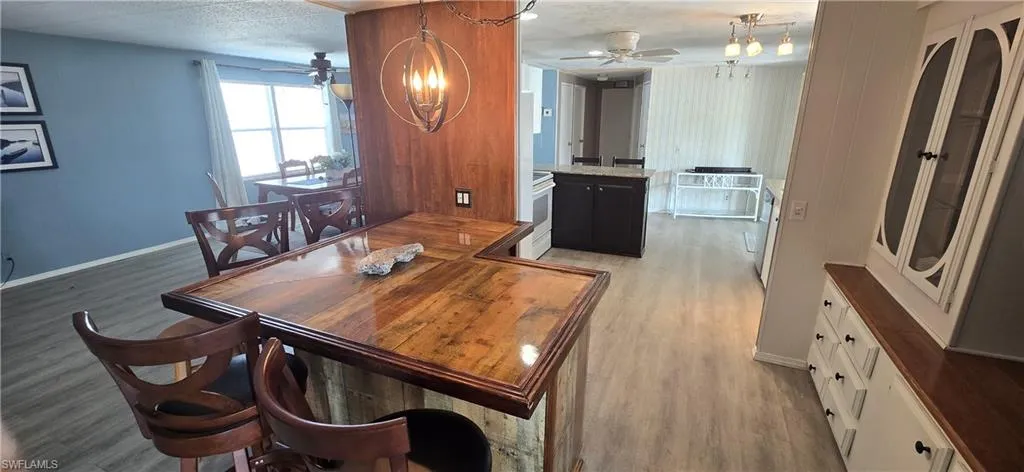 Dining space featuring ceiling fan and light wood-type flooring