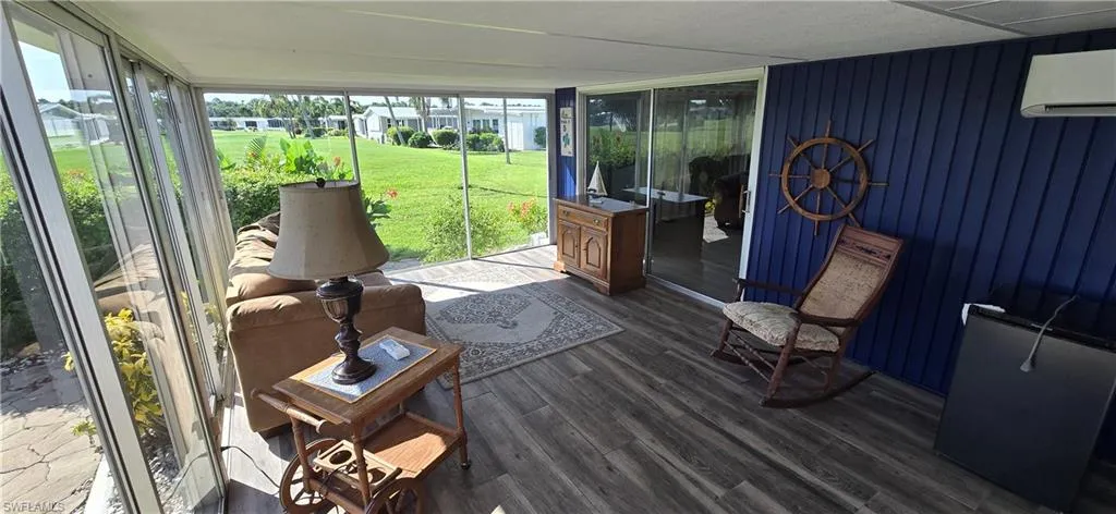 Sunroom / solarium featuring a wall mounted air conditioner