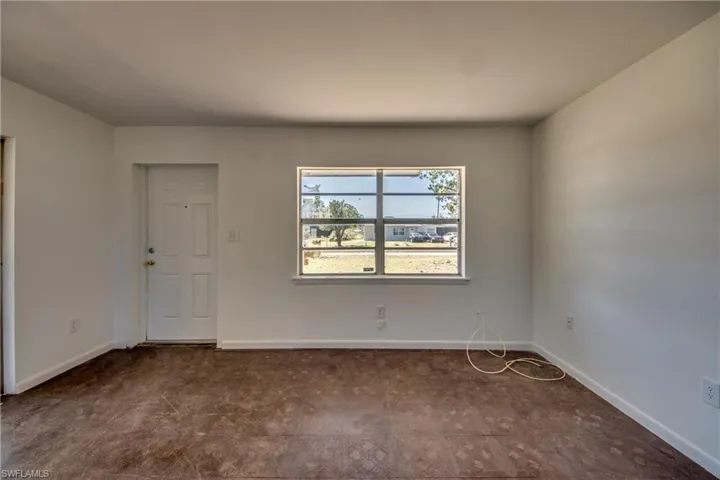Unfurnished room featuring baseboards
