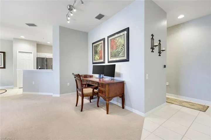 Home office featuring recessed lighting, light tile patterned floors, and light carpet